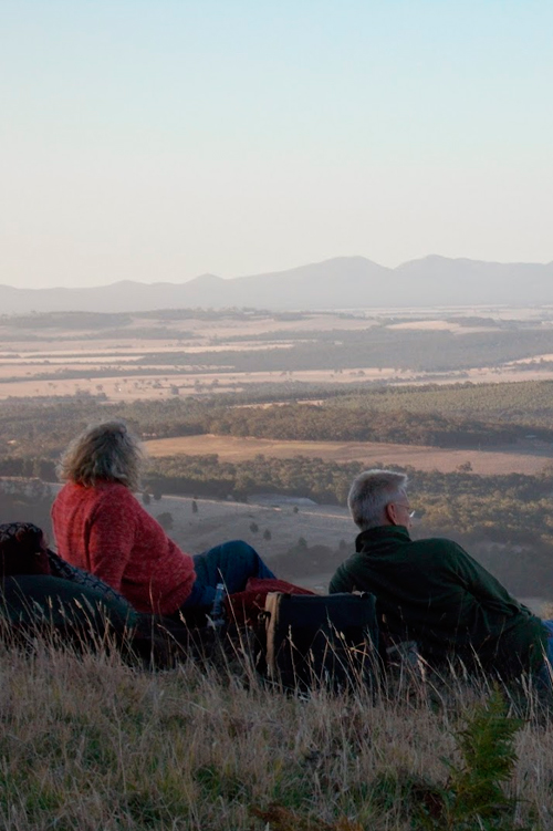 A couple looking over the Stirling Range from the Porongurup Range